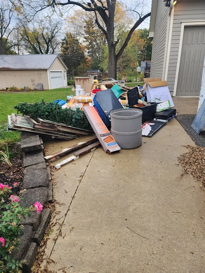 Dumpster being loaded with debris for Estate Cleanout Dumpster Rental in Northfield